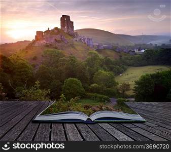 Beautiful dreamy fairytale castle ruins against romantic colorful sunrise coming out of pages in magical book creative concept