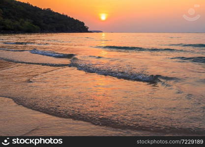 Beautiful early sunset over and Wave of the sea on the sand beach the horizon Summer time at hat sai kaew beach in Chanthaburi Thailand.