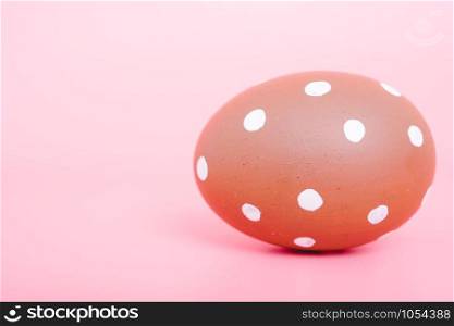 Beautiful Easter Brown egg color on pink background, Easter day concept