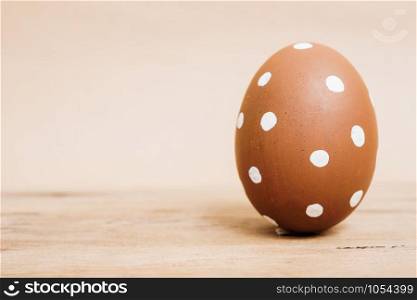Beautiful Easter Brown egg on wooden background, Easter day concept