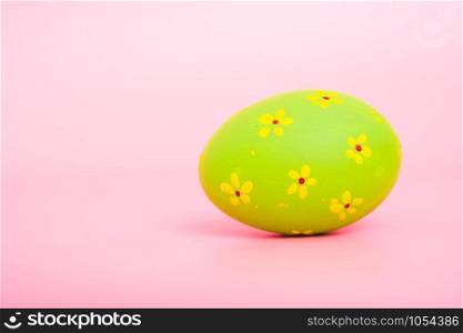 Beautiful Easter green egg color on pink background, Easter day concept