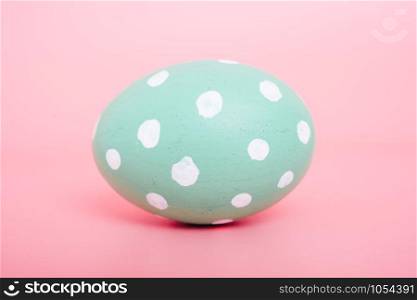 Beautiful Easter Green egg color on pink background, Easter day concept