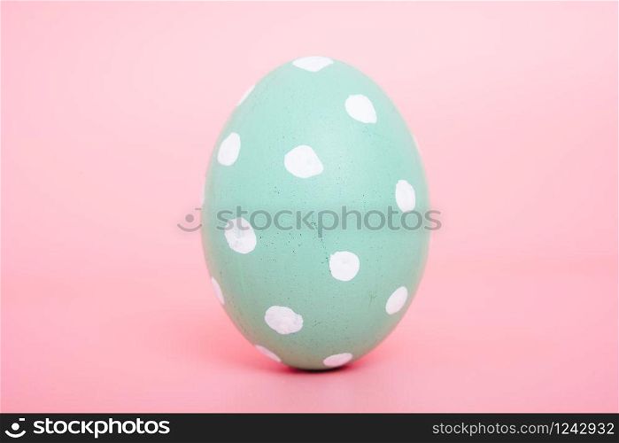 Beautiful Easter Green egg color on pink background, Easter day concept