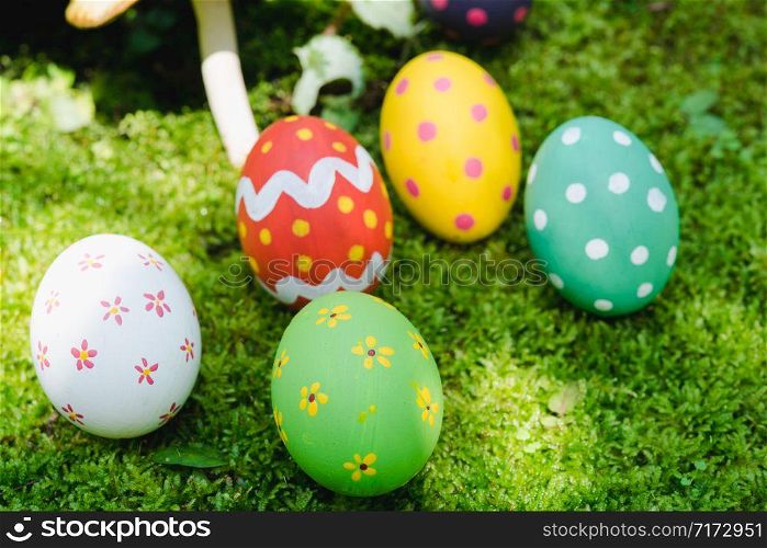 Beautiful Easter multi color egg on garden green grass, Easter day concept