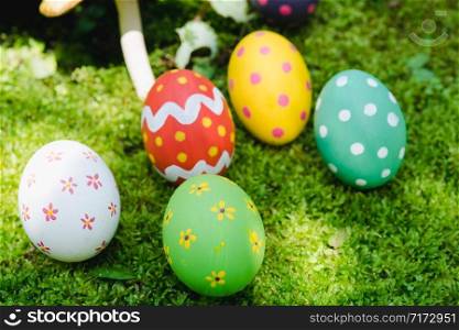 Beautiful Easter multi color egg on garden green grass, Easter day concept