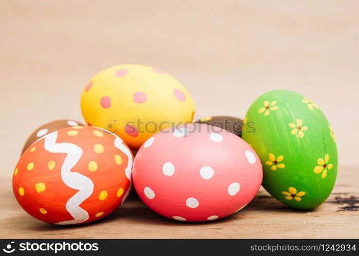 Beautiful Easter multi color egg on wooden background, Easter day concept