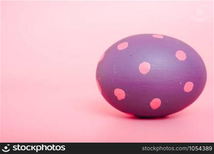 Beautiful Easter purple egg color on pink background, Easter day concept