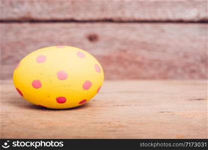 Beautiful Easter Yellow egg on wooden background, Easter day concept