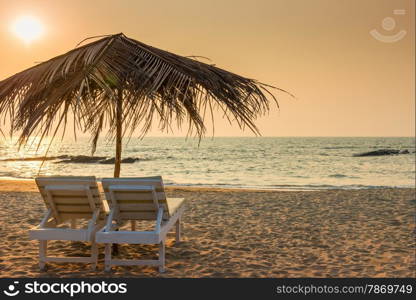 beautiful empty beach and a pair of sun loungers