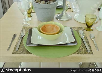 Beautiful empty plate setting on wooden dining table