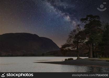 Beautiful epic digital composite landscape of Milky Way over Buttermere in Lake District