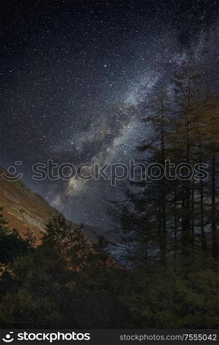 Beautiful epic digital composite landscape of Milky Way over Hallin Fell in Lake District