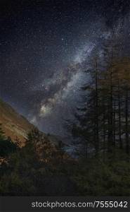 Beautiful epic digital composite landscape of Milky Way over Hallin Fell in Lake District