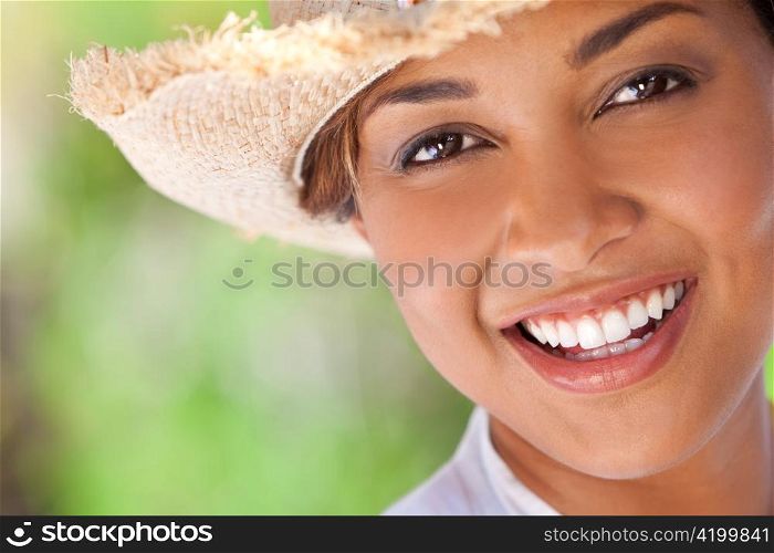 Beautiful Ethnic Mixed Race Woman Laughing In Straw Cowboy Hat