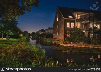 Beautiful evening in Netherlands. Lovely Dutch houses canal and pant reflections