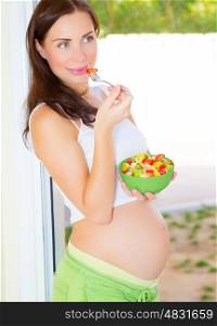 Beautiful expectant girl eat fresh vegetable salad, pregnant model at home, healthy pregnancy concept&#xA;