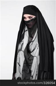 Beautiful eyes woman wearing fashion burka on grey background