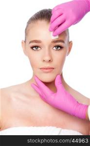 Beautiful face cleansing Cosmetic skincare spa beauty treatment with pink gloves and sponge, on white.