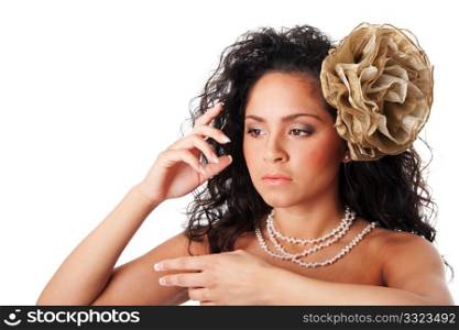 Beautiful face of a Caucasian Hispanic fashion model woman with clear skin, wearing a pearl necklace and a fake flower in curly hair, isolated.