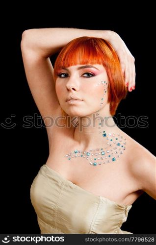 Beautiful face of a redhead Caucasian girl with rhinestones and hand over her head, isolated