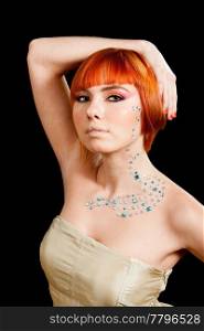 Beautiful face of a redhead Caucasian girl with rhinestones and hand over her head, isolated
