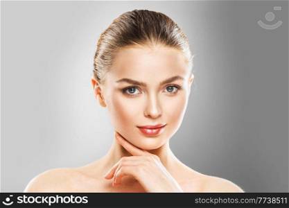 Beautiful face of young adult woman with clean fresh skin. Beautiful young adult woman