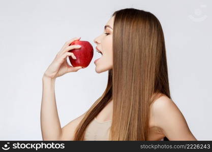 Beautiful Face of Young Woman with Clean Fresh Skin close up. Beauty Portrait. Beautiful Spa Woman Smiling. Perfect Fresh Skin. Pure Beauty Model. Youth and Skin Care Concept. Beautiful Woman with Clean Fresh Skin holding apple