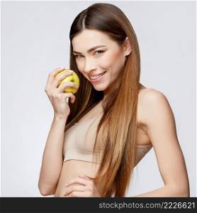 Beautiful Face of Young Woman with Clean Fresh Skin close up. Beauty Portrait. Beautiful Spa Woman Smiling. Perfect Fresh Skin. Pure Beauty Model. Youth and Skin Care Concept. Beautiful Woman with Clean Fresh Skin holding apple