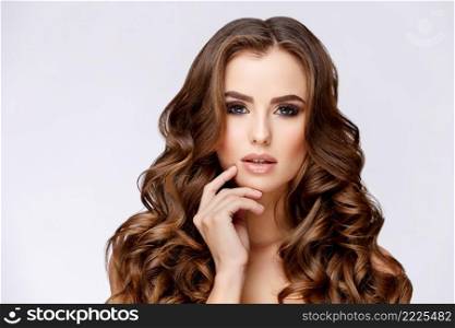 Beautiful Face of Young Woman with Clean Fresh Skin close up on light grey background. Beauty Portrait. Beautiful Woman Smiling. Perfect Fresh Skin. Pure Beauty Model. Youth and Skin Care Concept. Beautiful Woman with Clean Fresh Skin