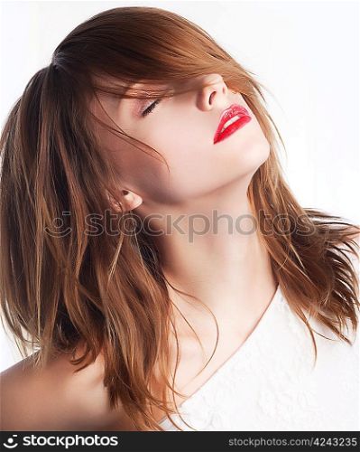 Beautiful face of young woman with clean skin and long hairs. Chic red lips
