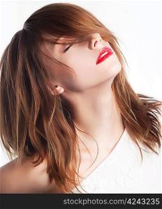 Beautiful face of young woman with clean skin and long hairs. Chic red lips