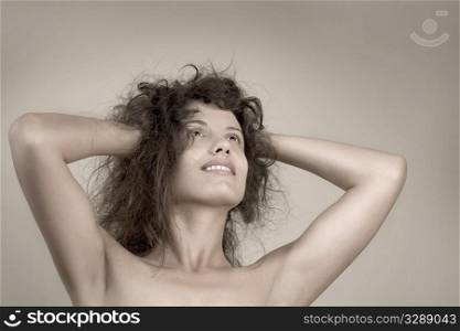 Beautiful face of young woman with clean skin. Girl with long curly hairs.