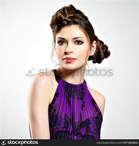 Beautiful face of young woman with stylish hairstyle with pigtails design, poses at studio