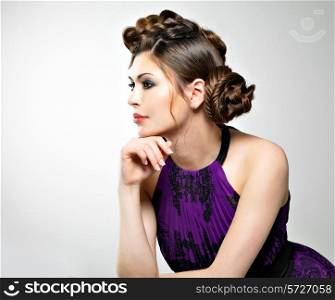 Beautiful face of young woman with stylish hairstyle with pigtails design, poses at studio
