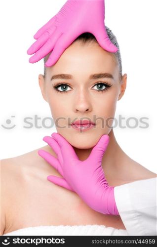 Beautiful face ready for Cosmetic skincare spa beauty treatment with pink gloves, on white.