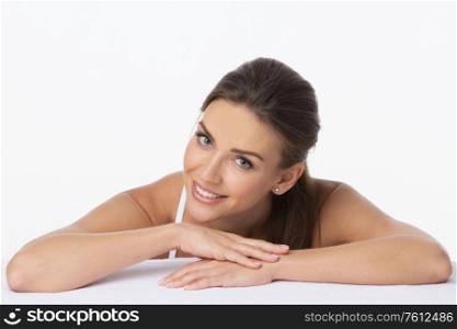 Beautiful face skincare beauty woman lying down on arms isolated on white background. Beautiful woman lying isolated