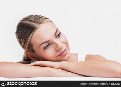 Beautiful face skincare beauty woman lying down on arms isolated on white background. Beautiful woman lying isolated