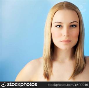Beautiful face woman over blue background, sensual female portrait, european model girl, healthy young lady, spa and beauty care concept