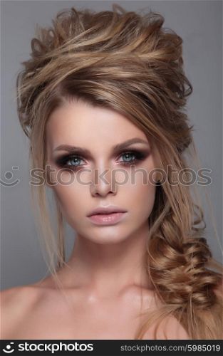 Beautiful face woman with modern curly hairstyle.