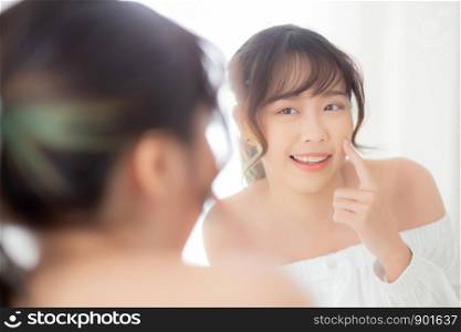 Beautiful face young asian woman with happy smiling and looking mirror, makeup of beauty facial girl with skincare and cosmetic treatment, refresh of female and clean for charming, healthy concept.