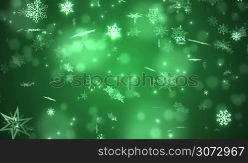 Beautiful falling snowflakes - green winter background. Seamless loop.