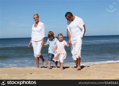 Beautiful family at the seaside in summertime