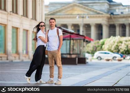 Beautiful family outdoors on background of Kazan Cathedral in Saint Petersburg. Coulpe at the summer day in Saint Petersburg