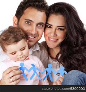 Beautiful family together isolated on gray background, happy young parents carry little daughter, people-shaped blue paper bonding toy in hands, togetherness concept
