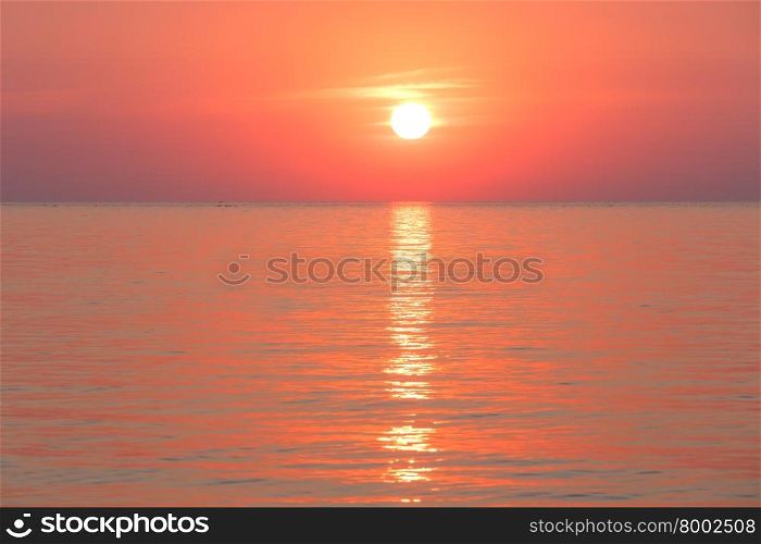 Beautiful fascinate morning sea view with sunrise and sun track on surface.