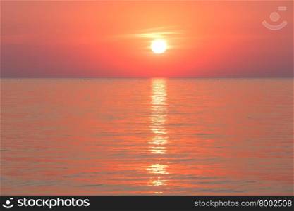 Beautiful fascinate morning sea view with sunrise and sun track on surface.