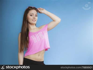 Beautiful fashion girl long hair in summer clothes sunglasses copy space. Studio shot on blue background