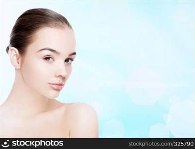 Beautiful fashion model girl natural makeup spa skin care portrait on blue bokeh background