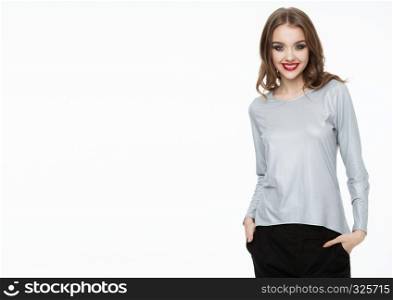 Beautiful fashion model wearing silver grey top and black pants on white background