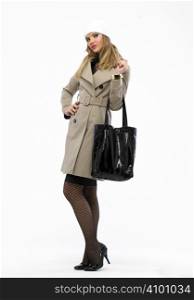 Beautiful fashion woman with trench and a bag